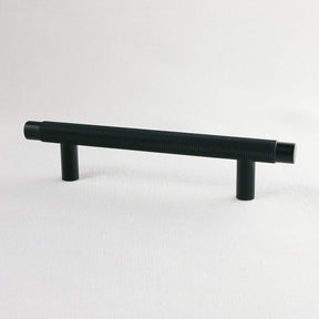 Matte black knurled kitchen cabinet pulls. Potter and Clay